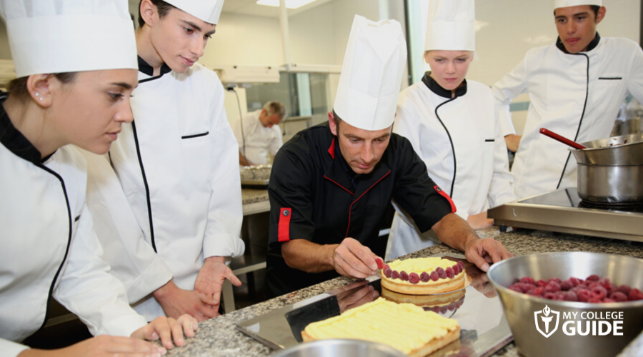 students watching the mentor in a vocational school for chef