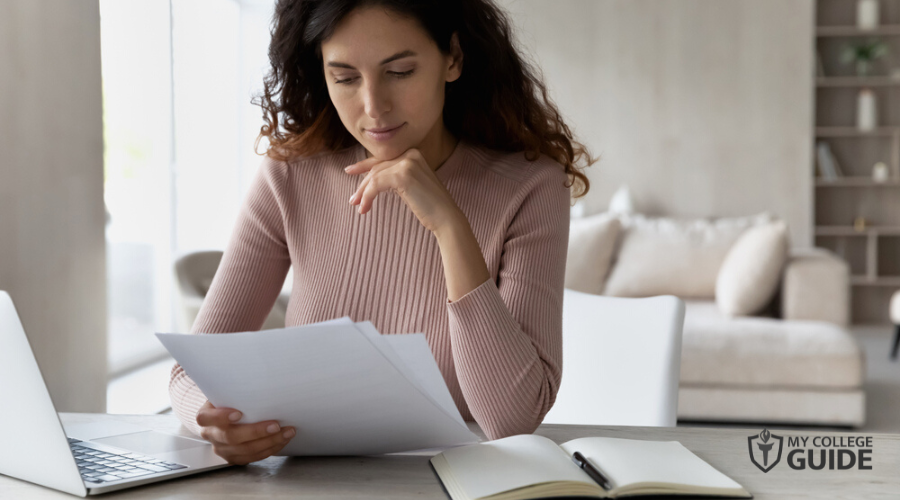 Woman reviewing her masters credits for Online PhD Degree