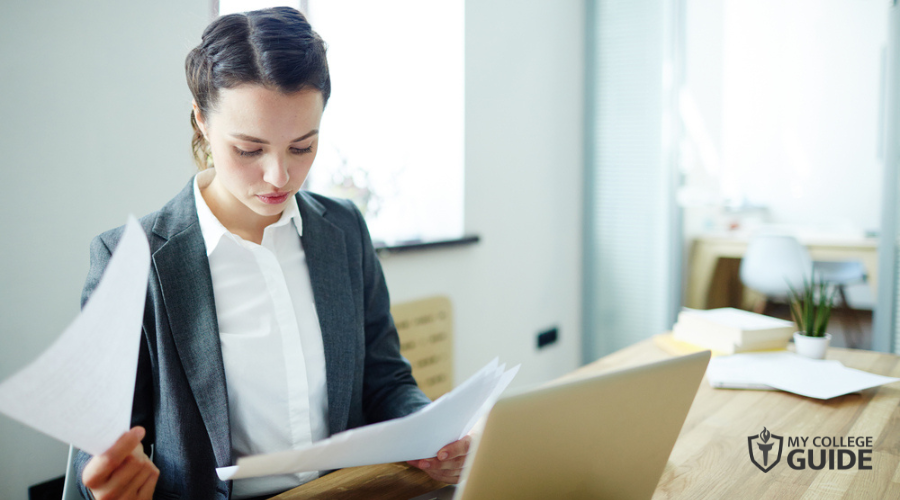 young woman working with papers in office