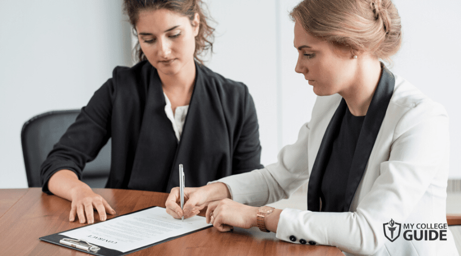Contract Specialist with a client signing a document
