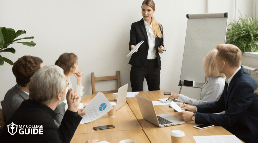 businesswoman giving presentation to business team
