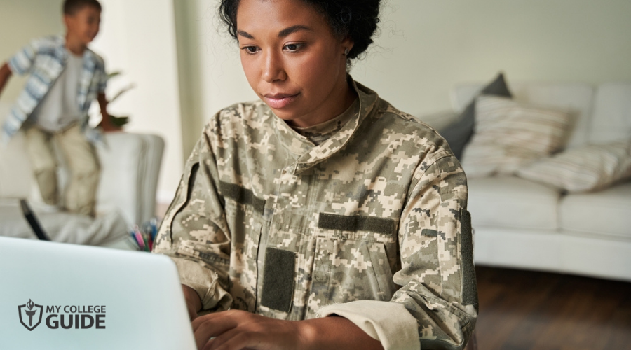 Focused woman soldier using laptop