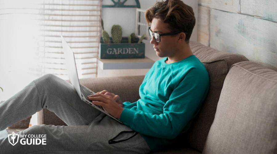 Student who takes an online degree, sitting relaxed at home