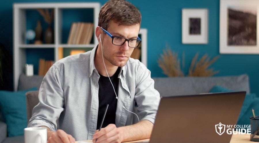 Adult man focused on his online college lecture
