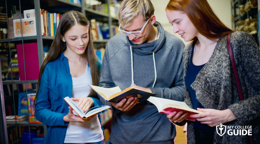 Students with local scholarship, doing research in the library
