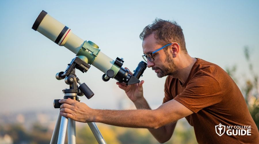 Astronomer looking through his astronomy telescope