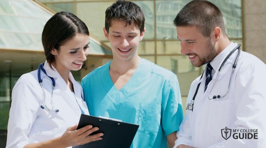 High School Medical Intern discussing with two doctors