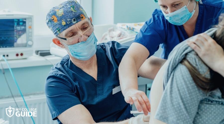 Two Nurse Anesthetists giving epidural anesthesia