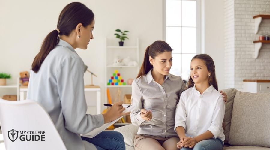 School Psychologist discussing with a mother and child