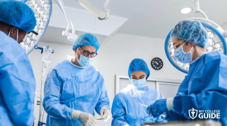 Registered Nurses assisting a doctor in operating room