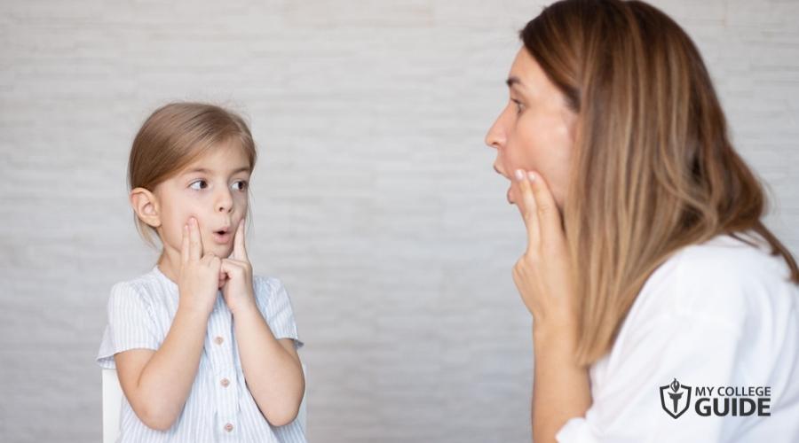 Speech-language pathologist with a child patient