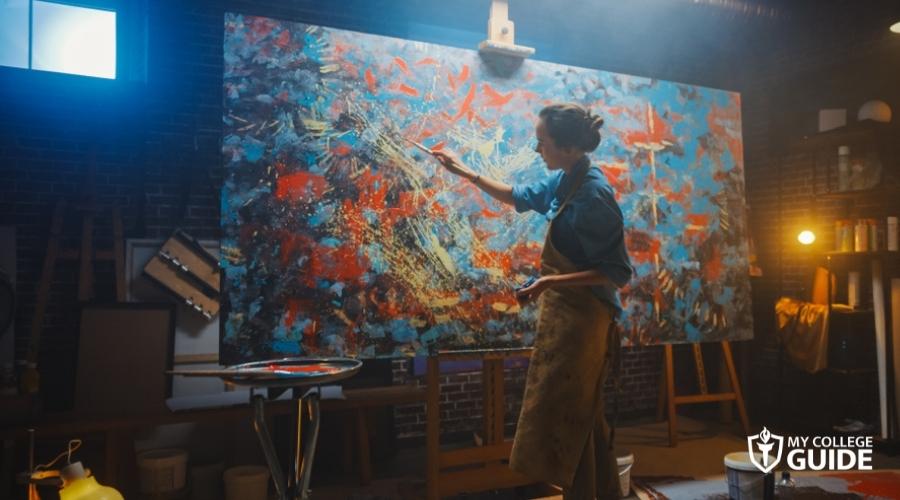 Artist painting a huge masterpiece