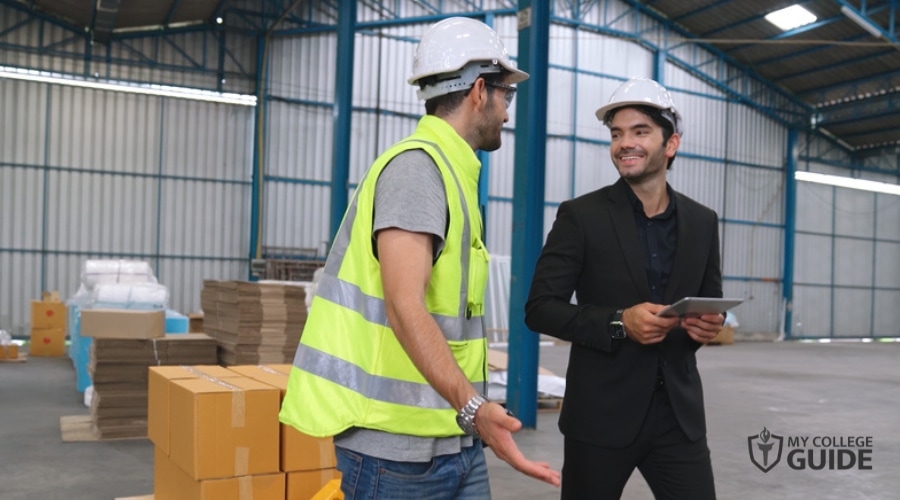 Supply Chain Manager discussing with a staff