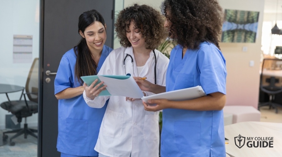 Nurses and doctor reviewing hospital records