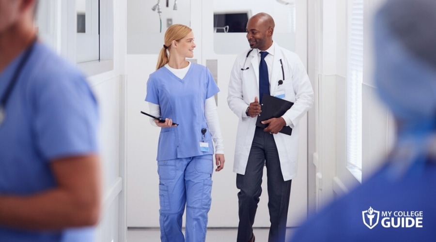 Nurse and doctor talking while walking in the hallway