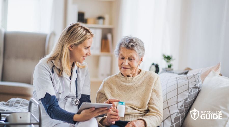 Licensed Vocational Nurse discussing with elderly patient