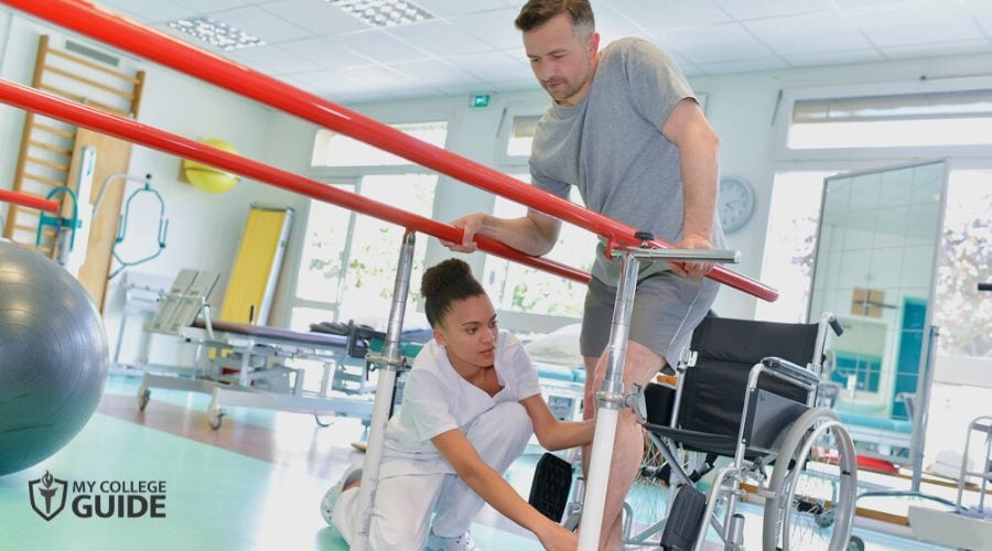 Physical Therapist guiding a patient move his feet