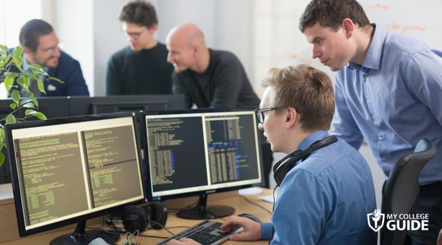Computer Operations Manager guiding a Software Developer
