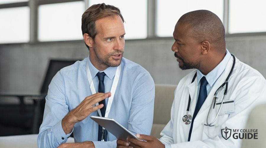 Healthcare Administrator talking to a doctor in hospital