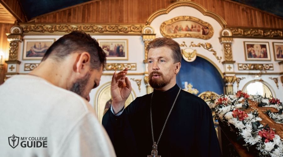 Clergy giving spiritual guidance to a church goer