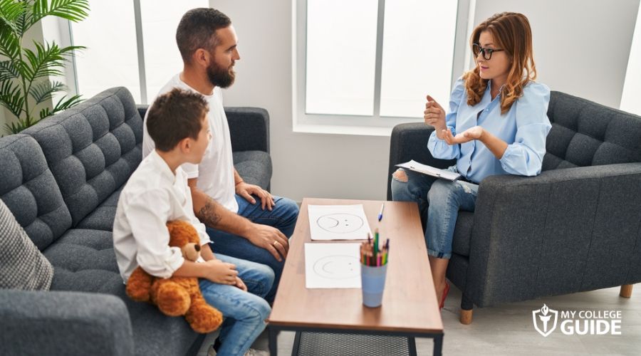 Child psychologist discussing with the father of patient