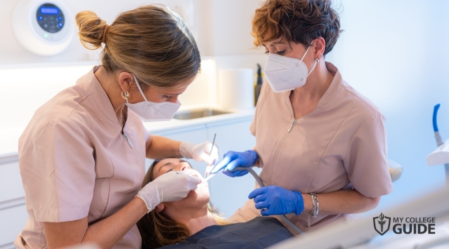 dental assistant helping a dentist in a clinic